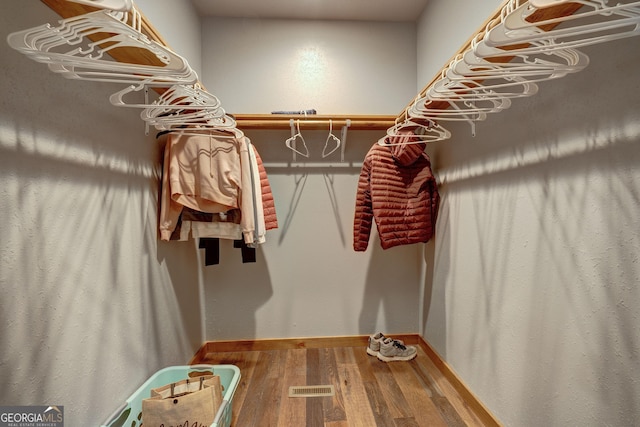 spacious closet with visible vents and wood finished floors