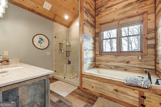 full bath featuring visible vents, wood finished floors, a shower stall, lofted ceiling, and vanity