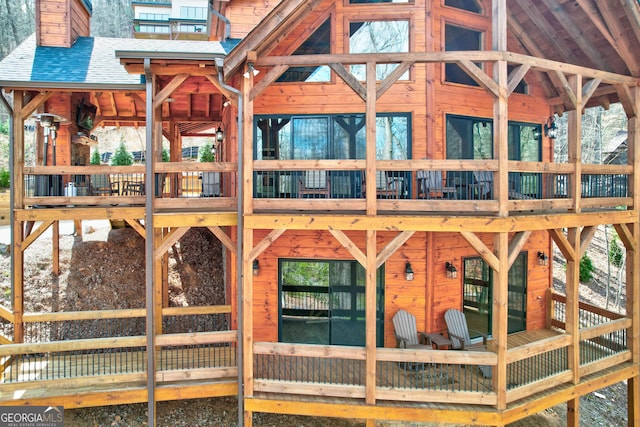exterior space with an exterior structure, gutters, a chimney, and a shingled roof