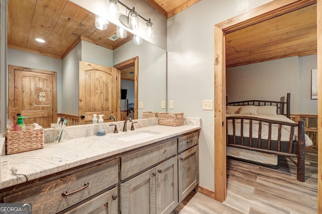 bathroom featuring visible vents, wood ceiling, wood finished floors, and vanity