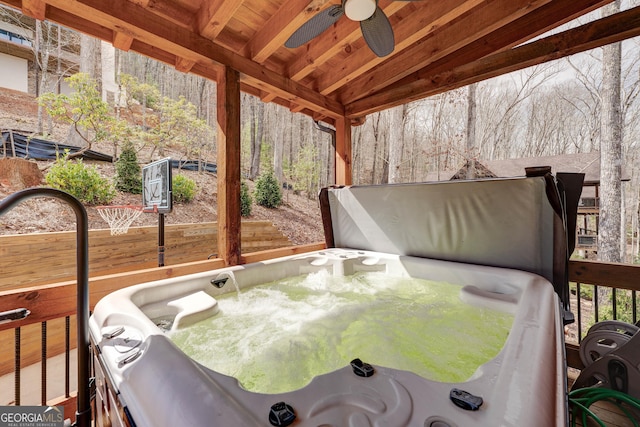 exterior space featuring a ceiling fan and a hot tub