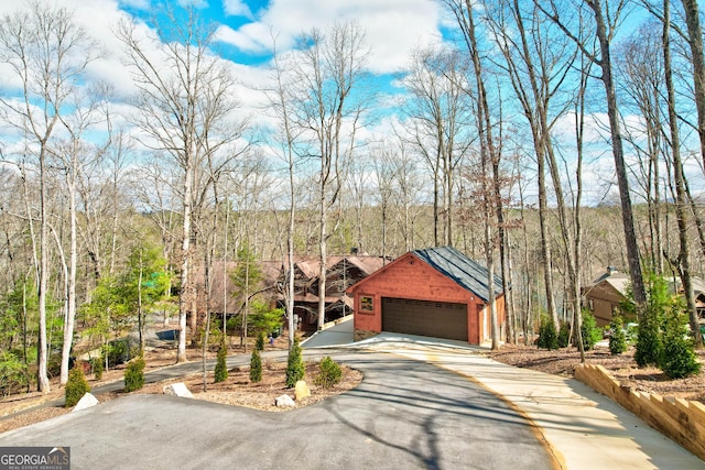view of front of home featuring a garage and aphalt driveway
