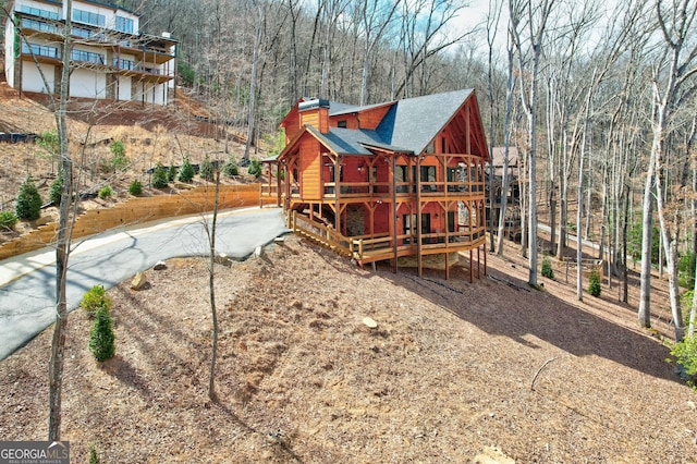 view of jungle gym featuring a view of trees