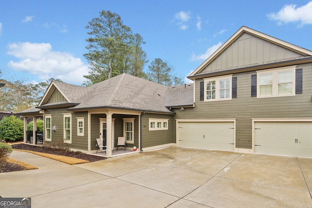 view of front facade featuring concrete driveway, an attached garage, board and batten siding, and a shingled roof