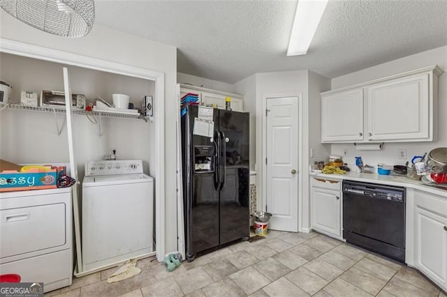 washroom featuring washer and dryer, a textured ceiling, and laundry area