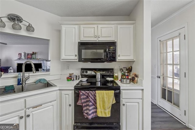 kitchen featuring a sink, white cabinetry, black appliances, and light countertops