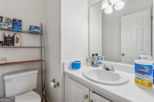 bathroom featuring toilet and vanity