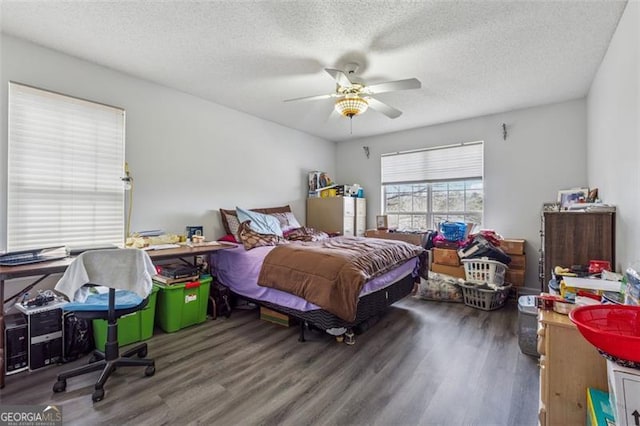 bedroom with a ceiling fan, wood finished floors, and a textured ceiling