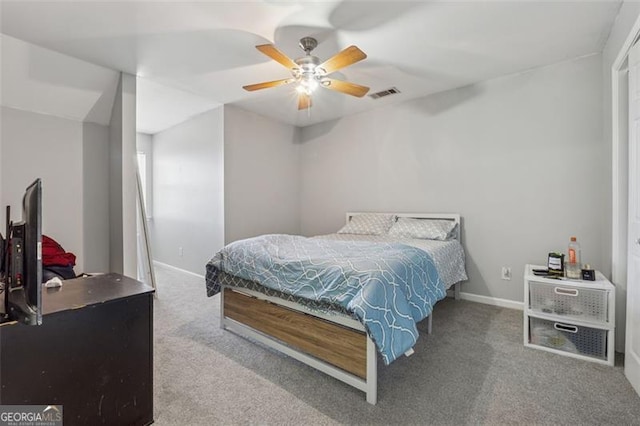 carpeted bedroom with visible vents, a ceiling fan, and baseboards