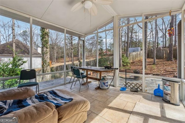 sunroom featuring vaulted ceiling, plenty of natural light, and ceiling fan