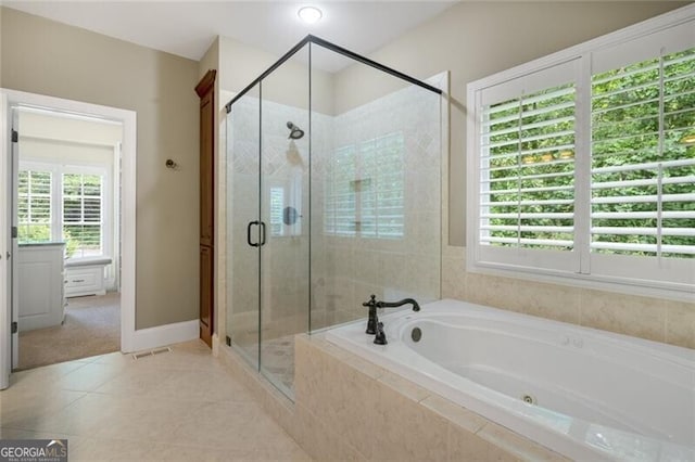 full bath featuring baseboards, a garden tub, a stall shower, and tile patterned flooring