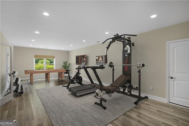 workout room with recessed lighting, wood finished floors, and baseboards