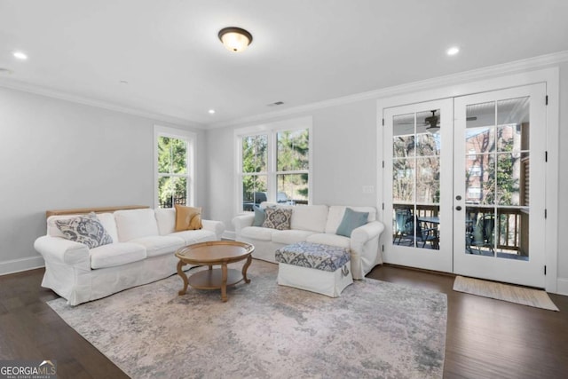 living area with crown molding, wood finished floors, and french doors