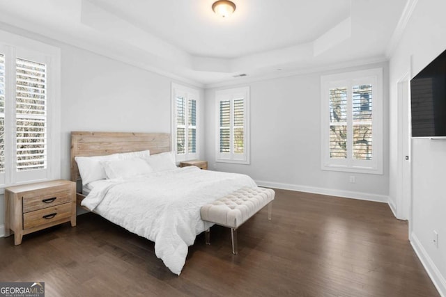 bedroom featuring baseboards, visible vents, dark wood-style flooring, crown molding, and a raised ceiling