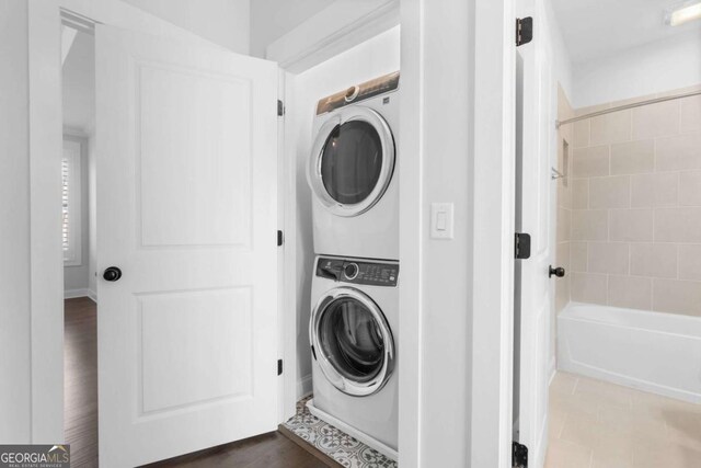 laundry room featuring stacked washer and dryer and laundry area