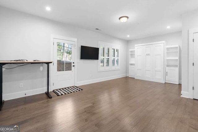 unfurnished living room with visible vents, recessed lighting, wood finished floors, and baseboards