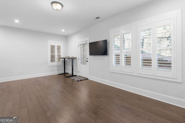 unfurnished living room with visible vents, recessed lighting, baseboards, and wood finished floors