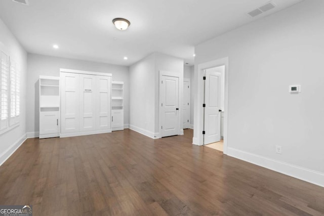 unfurnished bedroom featuring recessed lighting, visible vents, baseboards, and wood finished floors