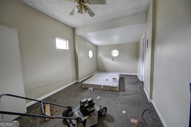 empty room with baseboards and a textured ceiling