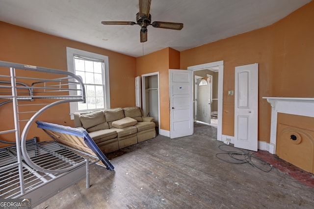 living room featuring baseboards and ceiling fan