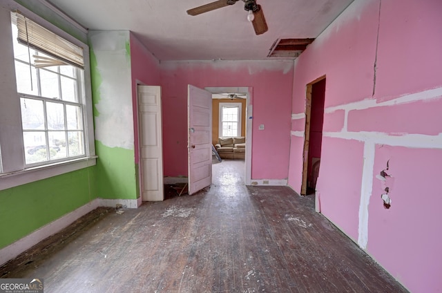 interior space with baseboards and a ceiling fan