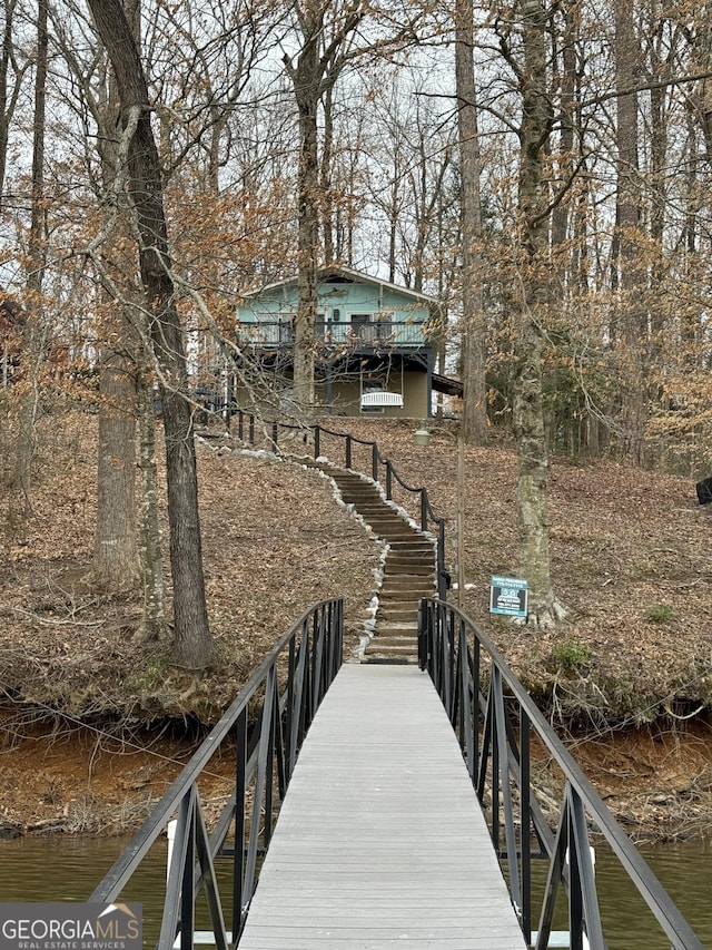 view of dock featuring stairway and a water view