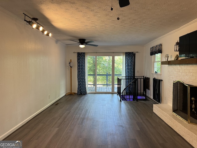 unfurnished living room featuring dark wood finished floors, a textured ceiling, and ceiling fan