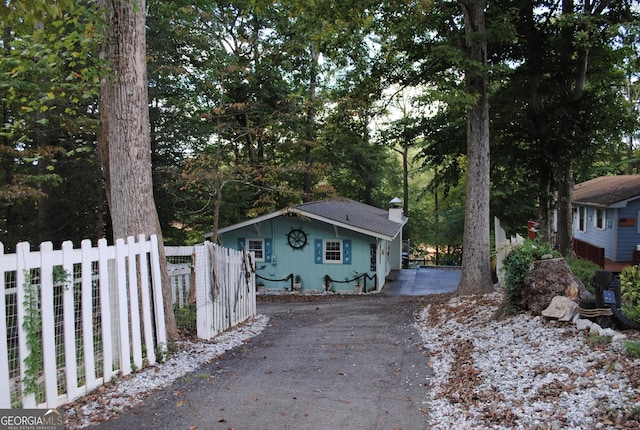 exterior space featuring fence and a chimney