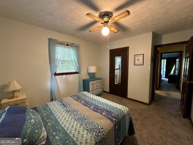 carpeted bedroom with a ceiling fan, baseboards, and a textured ceiling