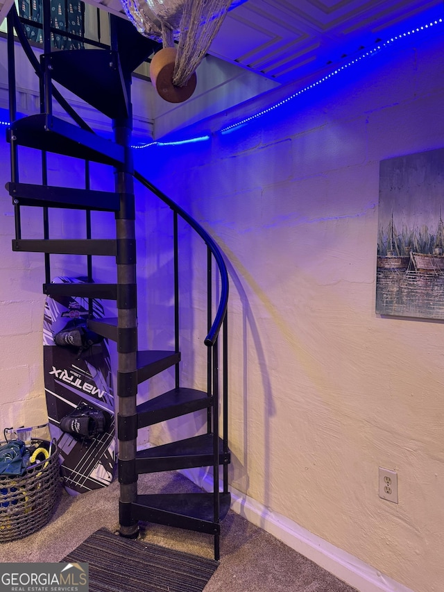 stairs with baseboards and carpet floors