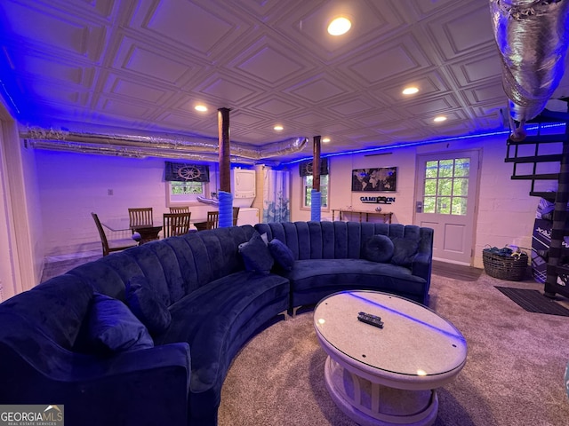 living room featuring recessed lighting, an ornate ceiling, and concrete block wall