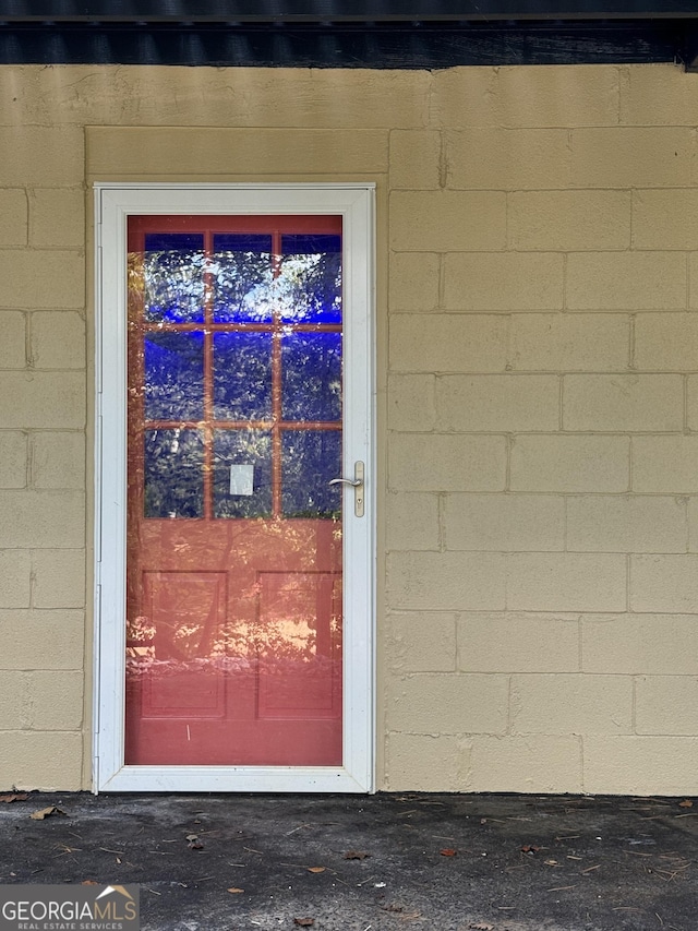 entrance to property with concrete block siding