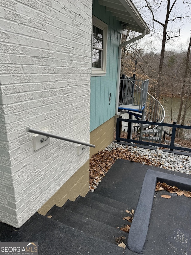 view of exterior entry with brick siding