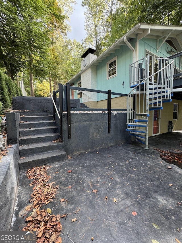 view of side of home featuring stairs