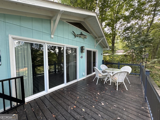 wooden terrace featuring outdoor dining area