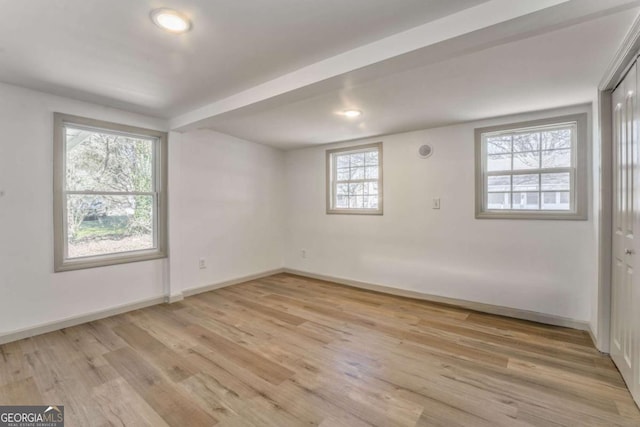 spare room with recessed lighting, baseboards, and light wood finished floors