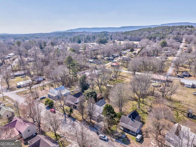 drone / aerial view featuring a mountain view and a forest view