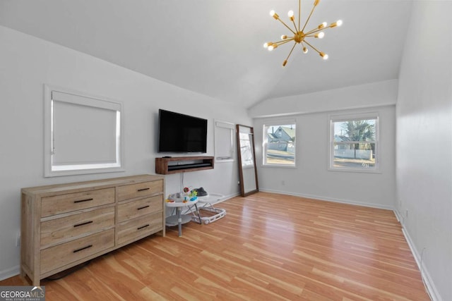 living room with light wood-type flooring, baseboards, and an inviting chandelier