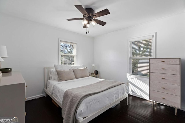 bedroom featuring ceiling fan, baseboards, and dark wood-style floors