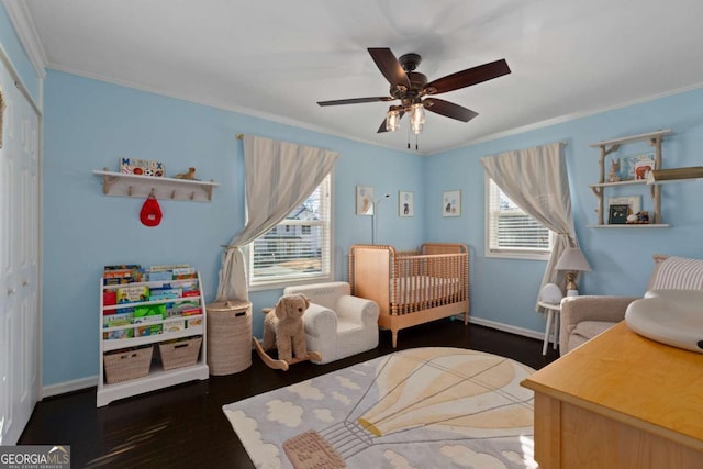 bedroom with a ceiling fan, wood finished floors, baseboards, and ornamental molding