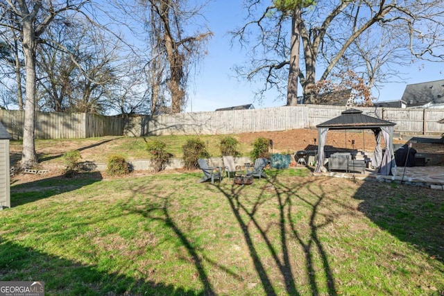 view of yard featuring a gazebo and a fenced backyard