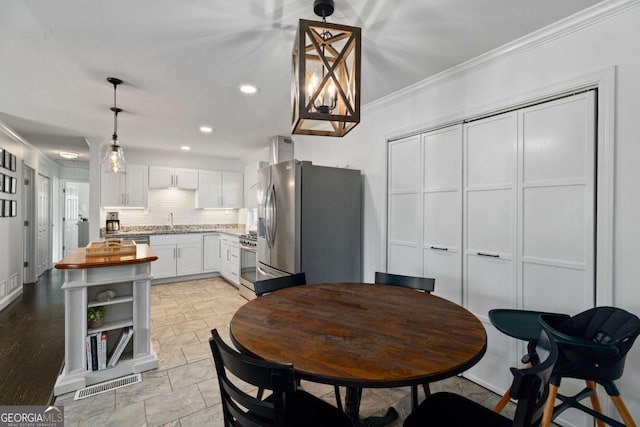 dining area featuring recessed lighting, visible vents, and crown molding