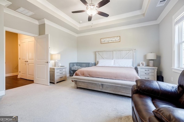 bedroom featuring visible vents, a raised ceiling, ceiling fan, and carpet floors