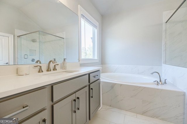 full bathroom with a shower stall, lofted ceiling, a bath, marble finish floor, and vanity