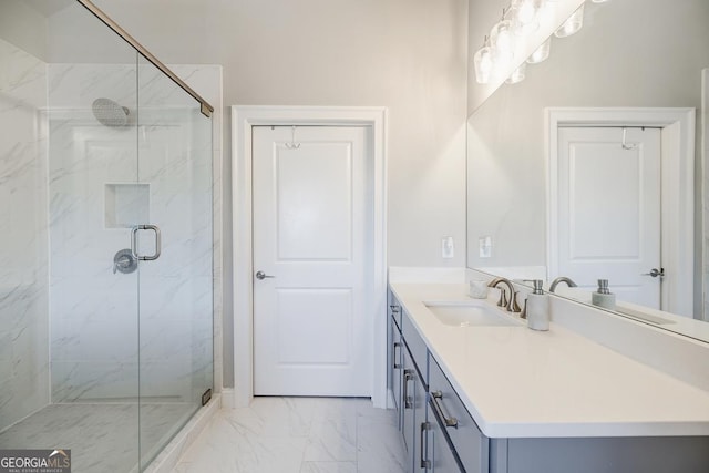 full bath with a marble finish shower, marble finish floor, and vanity