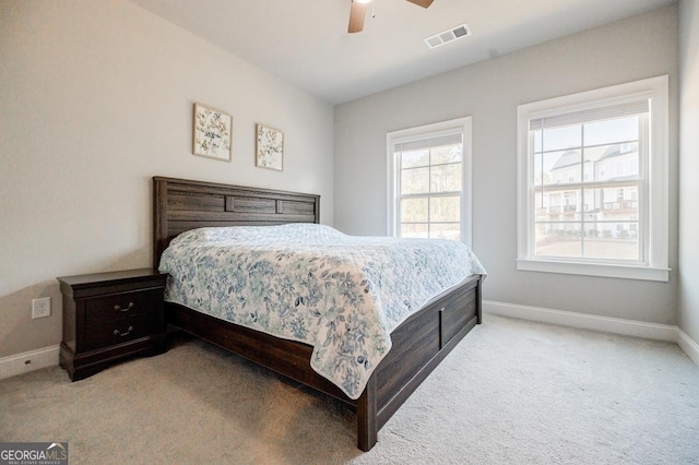 bedroom featuring visible vents, baseboards, carpet, and a ceiling fan