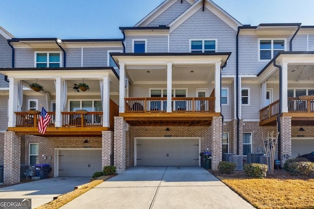 view of property with a garage, brick siding, central AC unit, and driveway