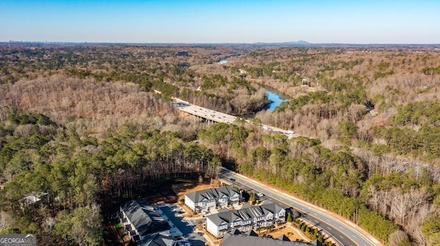 birds eye view of property featuring a wooded view