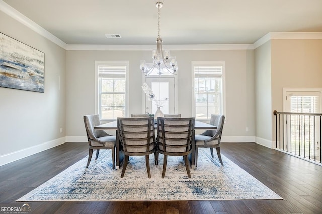 dining area featuring dark wood finished floors, visible vents, a healthy amount of sunlight, and an inviting chandelier