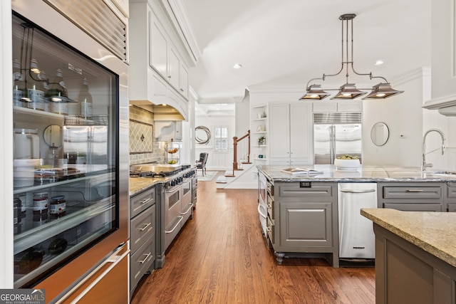 kitchen featuring gray cabinetry, high quality appliances, and crown molding